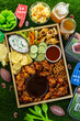 Football game day tail gate party tray filled with snack , beer and finger foods close up.