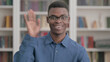 © stockbakers - Young African Man Waving, Welcoming