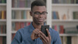 © stockbakers - Young African Man using Smartphone