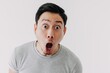 Funny shocked surprised closeup asian face man isolated on white background.