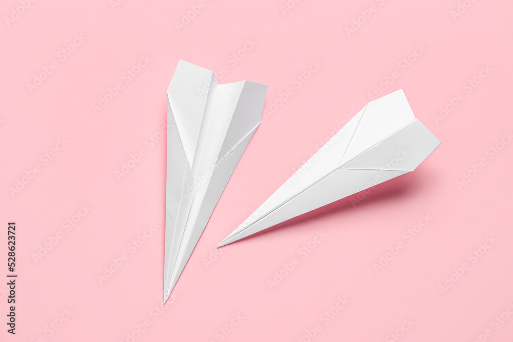 Paper planes on pink background