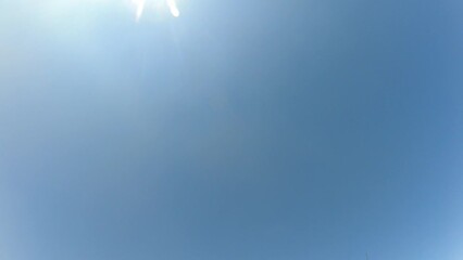 clear blue sky with a fog of clouds moving slowly