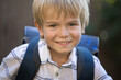 © Anna - Portrait of a happy schoolboy. cute smart cheerful pupil with a school backpack behind his back. back to school, knowledge and education concept