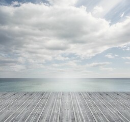 Poster - Bridge in ocean under cloudy sky