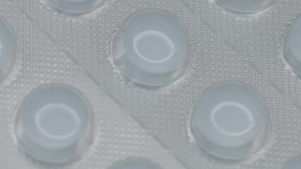 Poster - white pills in a blister are rotated in a circle