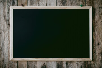 Abstract empty Blank chalkboard magnet with paper note and sticker note in wooden frame isolated on wooden background. empty space for add text.