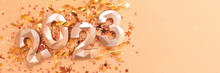 Banner With 2023 Gold Colored Numbers, Ribbons And Stars Confetti. Monochrome New Year's Composition With Place For Text.
