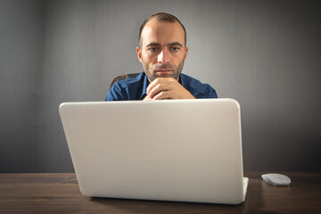 Wall Mural - Caucasian man working with laptop computer.