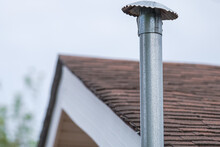 Selective Focus Of A Stovepipe On A Residential Roof In New Orleans, LA, USA
