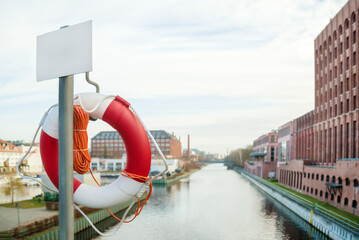 Lifebuoy on the city embankment. Coast security. For news of banner.