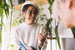 © BullRun - Happy Asian student smiling during positive conversation at daytime spending with cropped colleague for analyzing journalistic information in coworking space, joyful female designers talking indoors