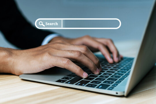 Website. businessman hand working on mobile laptop computer with virtual screen search button, searching browsing information, business finance, internet data technology and data search engine concept