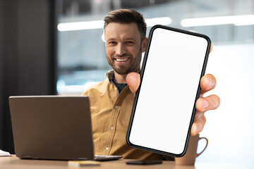 Poster - Business Offer. Smiling Millennial Man Demonstrating Big Blank Smartphone In Office