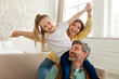 © Prostock-studio - Family Posing Having Fun, Daughter Sitting On Dad's Shoulders Indoor