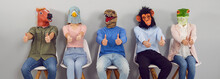 Team Of Quirky People With Funny Animal Faces Doing Like Gestures. Group Portrait Of Happy Young Men And Women Wearing Halloween Masks Sitting In Row And Giving Thumbs Up All Together