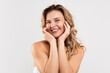© Prostock-studio - Positive Beautiful Middle Aged Female Posing Over Light Grey Background