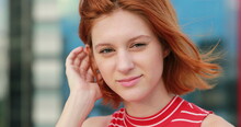 Redhead Young Woman Becoming Serious Looking To Camera