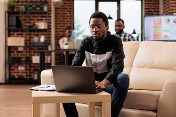 Wall Mural - african american man working on laptop pc to plan business presentation with data research and infor