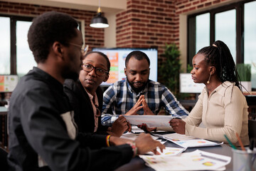 Wall Mural - office workers brainstorming ideas in business meeting, working together to create startup presentat