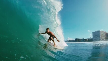 surfer on blue ocean wave getting epic barrel, surfing extreme sport, hd slow motion