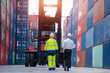 © visoot - Supervisor and Cargo container worker having discussion on working plan together in the container yard,Container in export and import business and logistics.