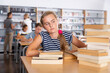© JackF - Bored teenage girl trying to prepare for exam in school library