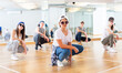 © JackF - Group of teenagers in casual clothes training hip-hop in class, learning modern dance movements