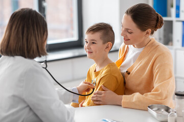 Sticker - medicine, healthcare and pediatry concept - happy smiling mother with little son and doctor with stethoscope at clinic