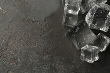 Crystal Clear Ice Cubes With Water Drops On Grey Table, Flat Lay. Space For Text