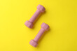 © New Africa - Stylish dumbbells on yellow background, flat lay