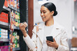 © M Einero/peopleimages.com - Supermarket, shopping and customer with smartphone check price, label or product information online. Retail consumer woman with food or grocery checking discount code or sales choice on a digital app