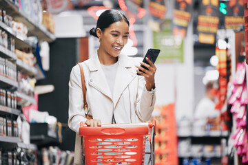 Phone, 5g internet and grocery shopping Indian woman reading a funny text or social media content. Comic web, mobile and online scroll at a retail food store with a happy customer smile from India