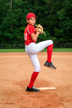 Teenage Baseball Player On The Pitchers Mound Preparing To Throw A Pitch