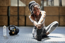 Portrait Of Woman Stretching With Music At Gym, Audio Podcast For Workout Motivation And Happy About Fitness Training On Floor At Health Club. African Athlete Or Sports Person Doing Exercise