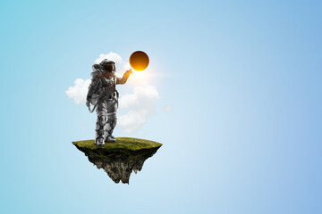 Wall Mural - spaceman on a light bulb