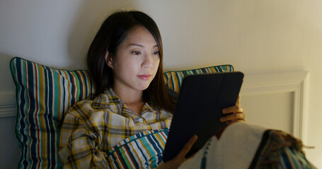 Poster - Woman read on tablet computer and lying on bed at night