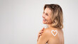 © Prostock-studio - Attractive Middle Aged Female With Heart Made Of Body Cream On Back
