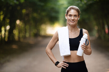 Wall Mural - Happy slim lady exercising at public park