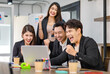 © Bangkok Click Studio - Group of millennial Asian young professional successful male businessmen and female businesswomen in formal suit sitting standing smiling screaming shouting holding fists up celebrating together