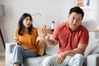 Emotional asian couple having fight at home