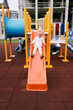 Little girl slides down the slide at the playground. High quality photo
