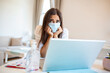 © Graphicroyalty - Businesswoman putting on protective mask working on laptop in the office. Focused company employee worker in protective facial mask working on laptop at home keeping covid 19 virus quarantine measures