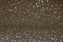An Extreme Close-up Of A Flat Piece Of Sparkly Vibrant Gold Coloured Craft Paper With A Very Shallow Depth-of-field Focal Point