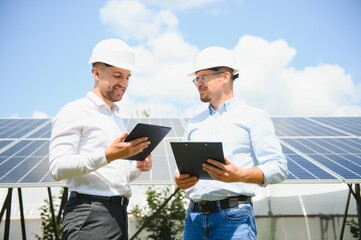 engineer and businessman planing new ecology project. around solar panel