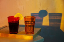 Two Glasses Of Orange And Yellow With Red Wine And Plums