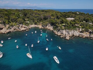 Aerial view of Cap d'Antibes and  Billionaire's Bay. Beautiful rocky beach near coastal path on the Cap d'Antibes, Antibes, France. Drone view from above of Côte d’Azur near Juan-les-Pins and Cannes.