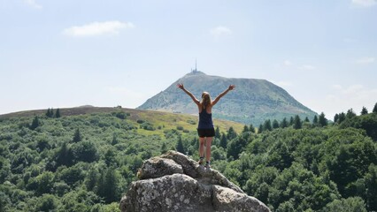 Wall Mural - hiker woman enjoying panorama view of mountain (puy de dome, auvergne in france)