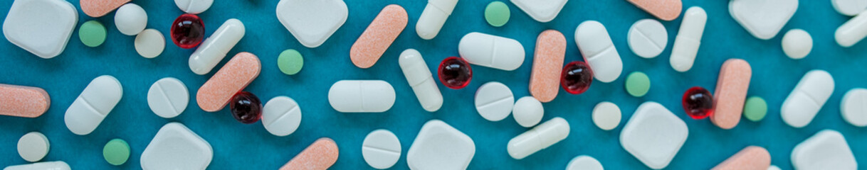 Many different pills on blue background. Copy space. Top view. Top view. Concept of pharmaceuticals, medicine