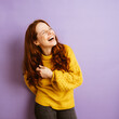 © contrastwerkstatt - laughing redhead woman looks happy to the side, copy space