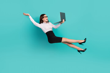 Wall Mural - Full size photo of lady marketer falling down levitate air with netbook discount isolated on cyan color background